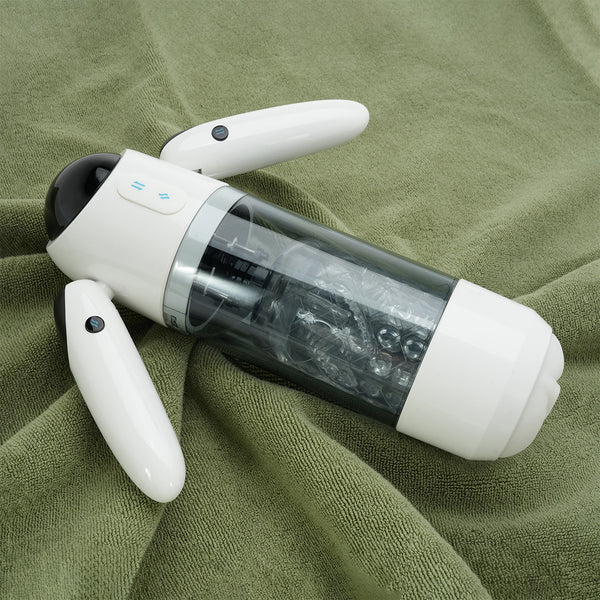 Robot Pro masturbateur automatique posé sur un tissu vert